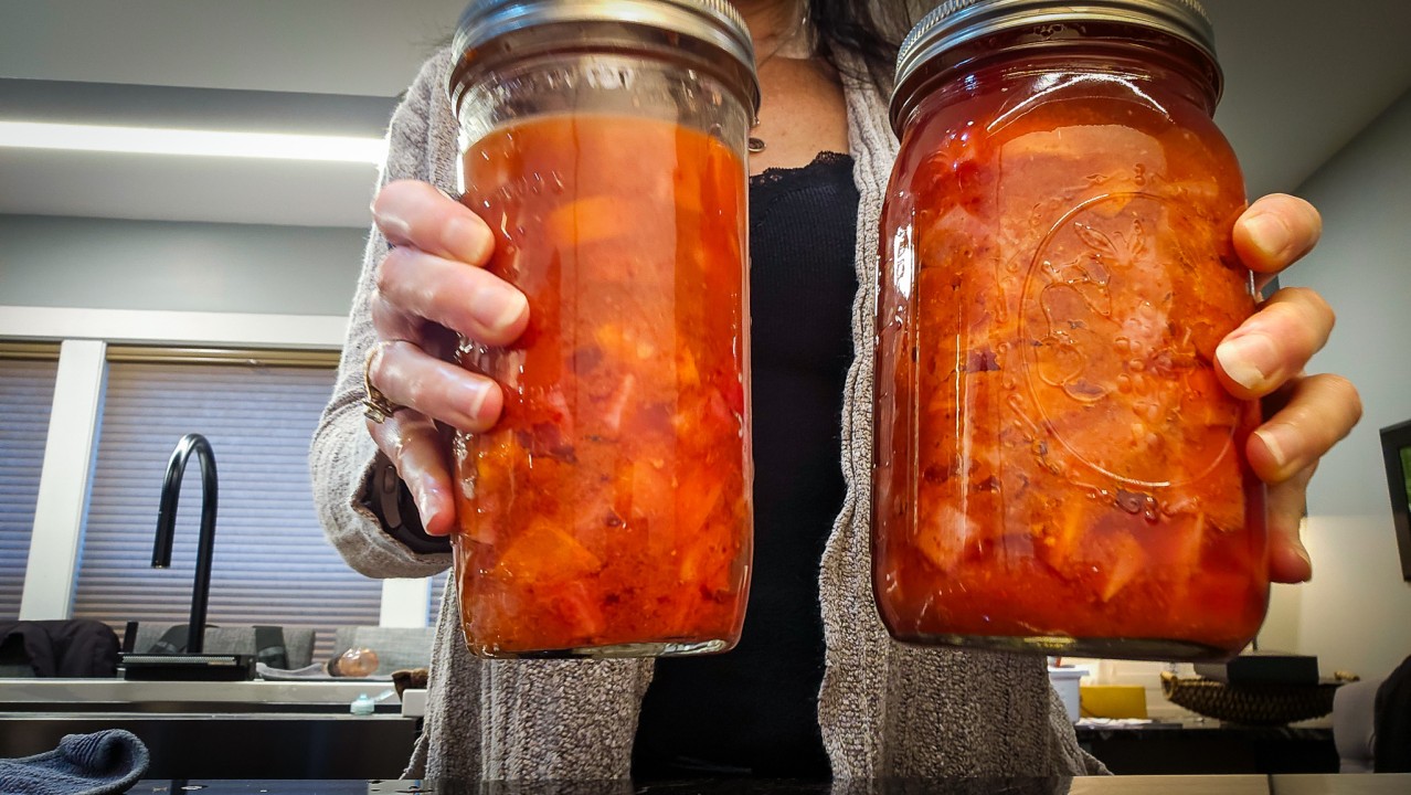 tara holding 2 jars of kimchi