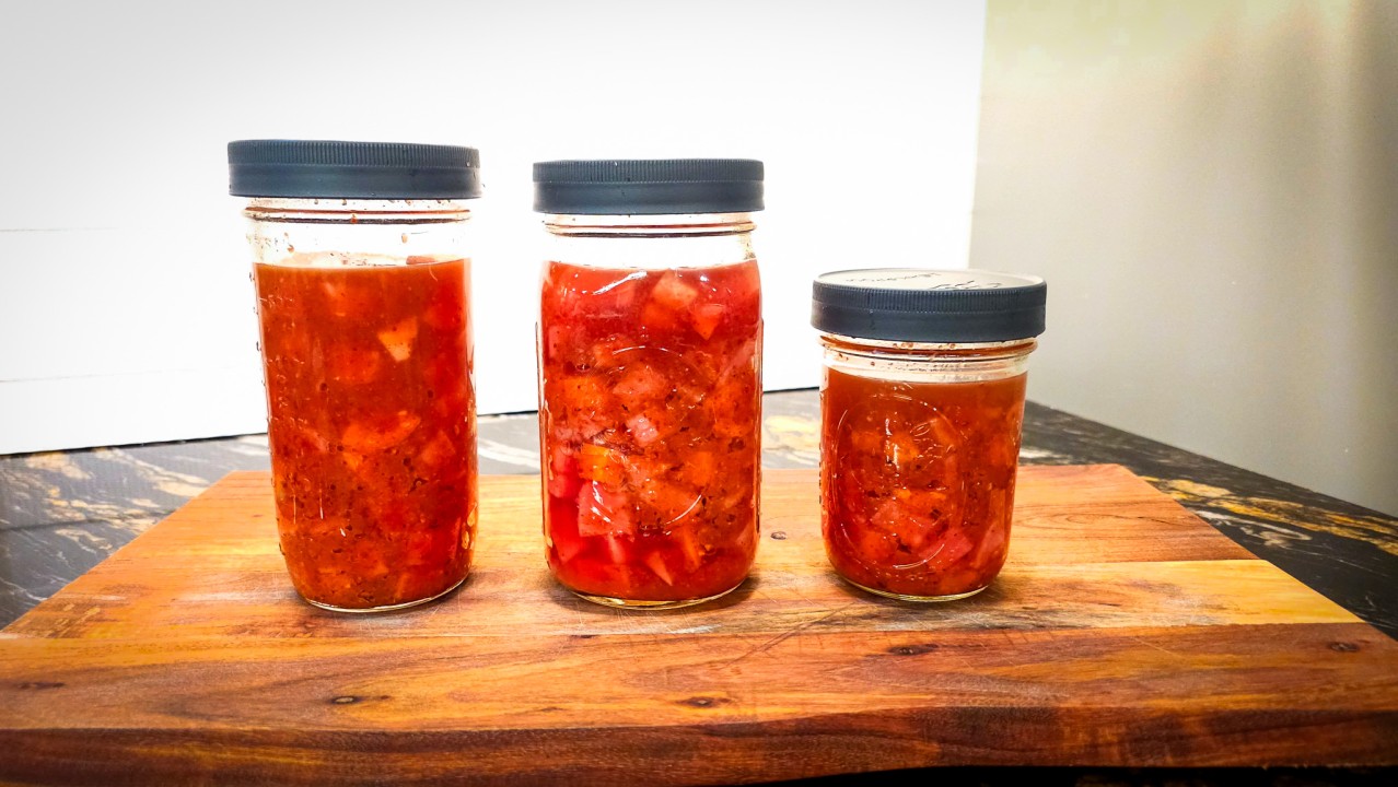 3 jars of kimchi on a cutting board